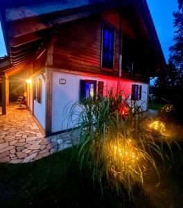 a house lit up at night with lights at La Dolce Vita im Tiroler-Holzhaus in Bad Elster