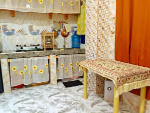a kitchen with a table and a chair in a room at KBC ZAI Baguio Staycation 2 in Baguio