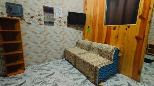 a couch sitting in a room with a tv at KBC ZAI Baguio Staycation 2 in Baguio