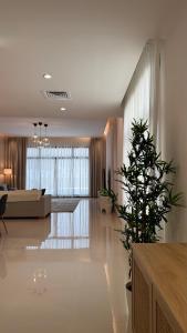 a living room with a couch and a plant in it at Seascape Villa Marine in Fujairah +33 photos