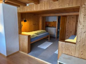 a small room with a bed inside of it at Studio Sternen in Hasliberg