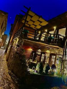 an old building at night with plants in front of it at Varosi Guesthouse in Edessa