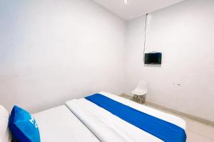 a hospital room with a bed and a tv at Staigo at SG Premium in Medan +27 photos