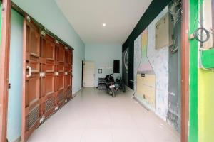 an empty hallway with a room with a motorcycle in it at Sg Premium Guest House By Helocus in Medan