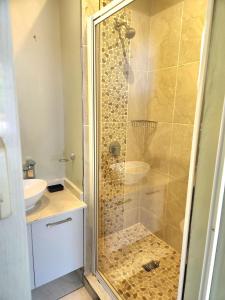 a bathroom with a shower and a sink at Durban North Cozy Haven in Durban