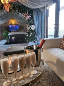 a living room with a christmas tree and a table at ADULT ONLY relax escape apartment hottub in Coagh