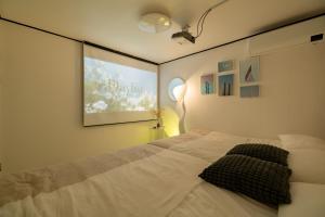 a bedroom with a bed with a picture on the wall at Naroo Stay - DDP and Jong-ro in Seoul