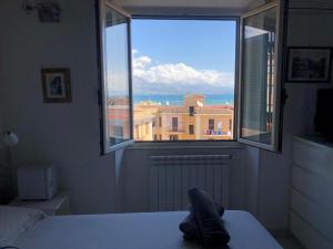a bedroom with a window with a view of a building at la dimora di Venere in Gaeta