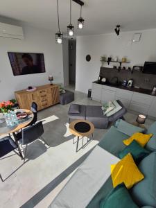a living room with a couch and a table at Apartament Szczęśliwy - 14 in Ustronie Morskie