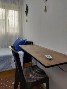 a wooden desk with a chair and a bed at Cozy Room & Modern Amenities 3 in Tetouan