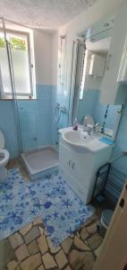 a blue bathroom with a sink and a shower at Heavenly House by the sea in Savudrija +79 photos