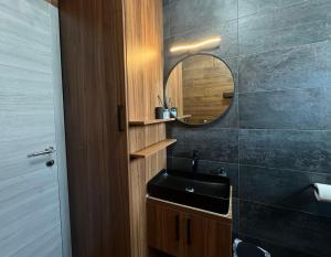 a bathroom with a black sink and a mirror at Golden Sunset 3 in Njivice +33 photos