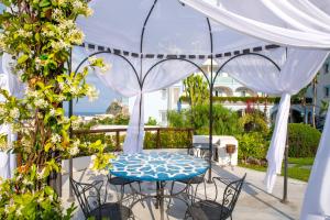 a table and chairs under a tent on a patio at Hermitage Resort & Thermal Spa in Ischia Town