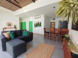 a living room with a couch and a dining room at Blissful Homes in Huacas