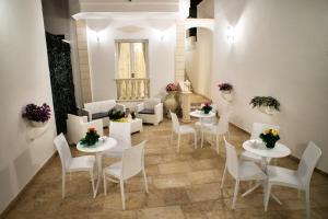a room with white tables and white chairs at B&B Corte dell' Immacolata in Taviano +64 photos