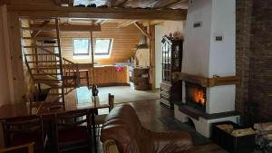 a living room with a staircase and a fireplace at Apalucha119 in Ludvíkov