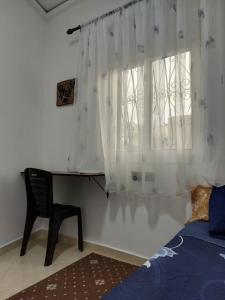 a bedroom with a bed and a window with curtains at Cozy Room & Modern Amenities 4 in Tetouan