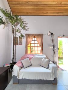 a bedroom with a bed with two pillows on it at Loft do Fotógrafo 4 - Poucos passos do Rio das Almas in Pirenópolis