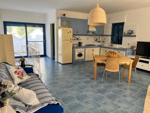 a kitchen with a couch and a table in it at Casa MARESOLE in Mattinata
