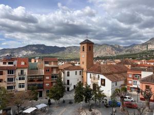 a view of a city with a clock tower at Ático Luz del Valle in Dúrcal