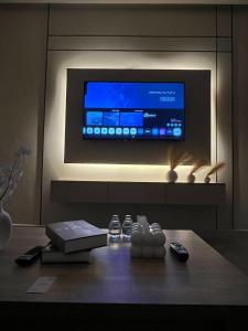 a room with a tv and remote controls on a table at Luxury Smart Entry Studio in Buraydah +3 photos