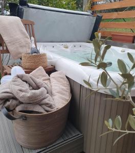 a bath tub with towels sitting next to a bath tub at Serenitá Vendégház in Nemesgulács