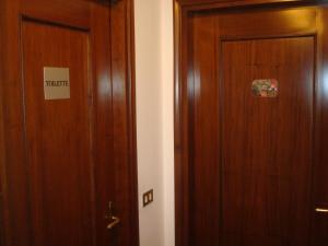 parę drewnianych drzwi w pokoju w obiekcie Cristina House w mieście Bassano del Grappa +8 zdjęć