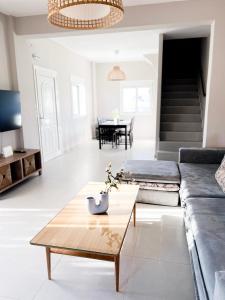 a living room with a couch and a coffee table at Casa De Vara in Nea Potidaea