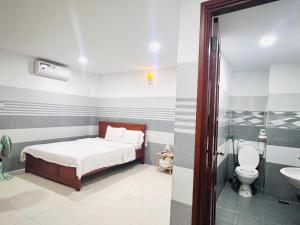 A bed or beds in a room at Luna House Hotel