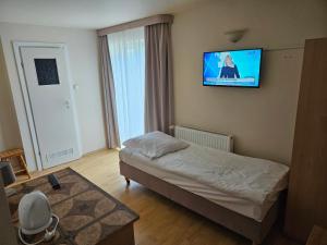 Postel nebo postele na pokoji v ubytování Piotruś Pan