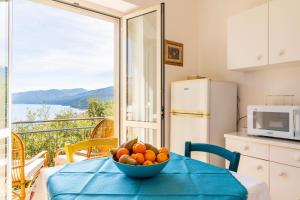 a bowl of fruit on a table in a kitchen at Casa Colombo in Cala Gonone