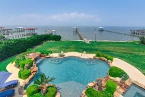 an aerial view of a swimming pool with the ocean at Private Dock and Pier Luxe Villa on Galveston Bay! in San Leon
