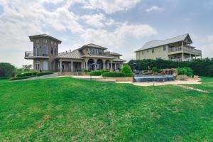 a large house with a large yard in front of it at Private Dock and Pier Luxe Villa on Galveston Bay! in San Leon