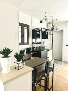 a kitchen and dining room with a wooden table and chairs at Savona Sea in Bari +9 photos