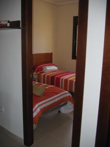 a group of three beds in a room at Family Townhouse 6 sleeps Maribel in Ciudad Quesada +27 photos