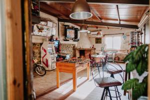 a kitchen with a table and chairs in a room at LARCADE Loft Industrial in Castillo de Bayuela