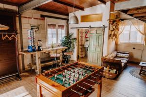 a living room with a foos ball on a table at LARCADE Loft Industrial in Castillo de Bayuela