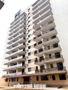 a tall white apartment building with balconies at Hils Studio in Bucharest
