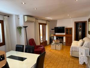 a living room with a table and chairs at Puebla de Farnals playa- Oasis Apartments - Costa de Valencia Beachside Stay in Puebla de Farnals +17 photos