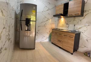 a kitchen with a stainless steel refrigerator in the corner at La Casa del Marino in Los Naranjos
