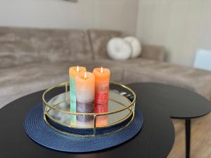 a table with three candles on top of it at Comfortable apartment in Ålesund in Ålesund
