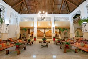 a lobby with couches and tables in a building at Occidental Caribe - All Inclusive in Punta Cana