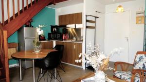a kitchen with a table and a kitchen with a staircase at FLOREVA 22 entre Plage et Thalasso - Internet fibre in Concarneau
