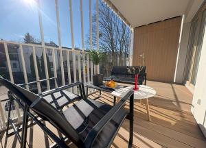 a patio with a table and chairs on a balcony at Baltic Apartment White Diuna Supernovi in Gdynia +21 photos