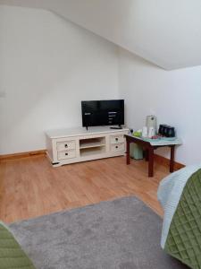 un soggiorno con TV a schermo piatto e tavolo di Charlestown bungalow a Dundalk