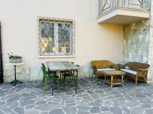 a patio with tables and chairs next to a building at Civico 7 in Clusane sul Lago