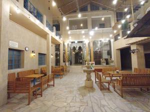 ein Restaurant mit Holztischen und -stühlen in einem Gebäude in der Unterkunft Hyba Heritage Guest House in Dubai