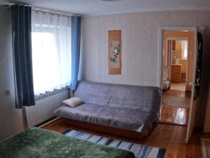 a living room with a couch and a window at Apartament pod mewą in Gdynia