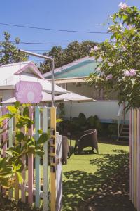 a white picket fence in front of a house at Candyland Vacation Rentals in Bocas del Toro