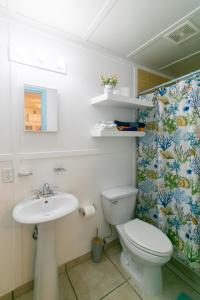 a bathroom with a toilet and a sink at Candyland Vacation Rentals in Bocas del Toro
